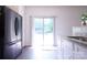 Bright kitchen featuring stainless steel refrigerator, hardwood floors, and sliding glass door to the backyard at 6919 Ware Rd, Charlotte, NC 28212