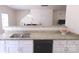 Bright, modern kitchen with stainless steel appliances and granite countertops seamlessly connecting to dining and living area at 6919 Ware Rd, Charlotte, NC 28212
