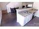 Modern kitchen featuring stainless steel sink, granite countertops, white cabinetry, and seamless flow to dining area at 6919 Ware Rd, Charlotte, NC 28212