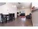 Open-concept living and dining area featuring hardwood floors and comfortable seating arrangements at 6919 Ware Rd, Charlotte, NC 28212