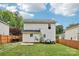 A fully fenced backyard ensures privacy, complementing the home's tidy exterior and green lawn, perfect for outdoor enjoyment at 719 Dawn Cir, Charlotte, NC 28213