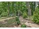 Serene backyard with a stone path, lush greenery, and a peaceful area for relaxation at 719 Dawn Cir, Charlotte, NC 28213