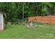 Secluded backyard featuring mature trees, a wood fence, and landscaping. The area provides a private outdoor retreat at 719 Dawn Cir, Charlotte, NC 28213