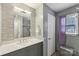 Bathroom with modern vanity, mirror, and tiled wall at 719 Dawn Cir, Charlotte, NC 28213