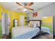 Cozy bedroom featuring bright yellow wall, comfortable bedding, and ample natural light at 719 Dawn Cir, Charlotte, NC 28213