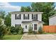 Charming two-story home with white siding, black shutters, and a lovely landscaped front yard at 719 Dawn Cir, Charlotte, NC 28213