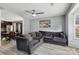 Comfortable living room with modern ceiling fan, grey walls, and a large sectional sofa at 719 Dawn Cir, Charlotte, NC 28213