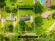 Aerial view showcases the property's layout on a lot surrounded by lush greenery and neighboring homes at 815 Lakeside Cir, Lancaster, SC 29720