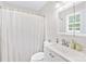 Bright bathroom with white vanity, framed mirror, and shower with white curtain at 815 Lakeside Cir, Lancaster, SC 29720