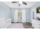 Cozy Bedroom room featuring a crib, dresser, modern fan and lots of natural light at 815 Lakeside Cir, Lancaster, SC 29720