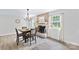 Cozy dining area with a brick fireplace and natural light from the windows at 815 Lakeside Cir, Lancaster, SC 29720