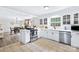 Modern kitchen with stainless steel appliances and white cabinetry overlooking the dining room at 815 Lakeside Cir, Lancaster, SC 29720