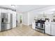 Spacious kitchen with stainless steel appliances and views into the living room at 815 Lakeside Cir, Lancaster, SC 29720