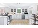 Bright kitchen with white cabinets, stainless steel appliances, and a view to the breakfast nook at 815 Lakeside Cir, Lancaster, SC 29720