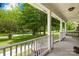 Inviting porch view with swing showcases the serene neighborhood and lush greenery at 815 Lakeside Cir, Lancaster, SC 29720