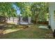 Spacious backyard with a trampoline, grass, and tree coverage, perfect for outdoor activities and relaxation at 820 Settlement St, Clover, SC 29710