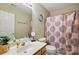 Well-lit bathroom featuring a vanity, toilet, mirror, and a shower with a stylish patterned curtain at 820 Settlement St, Clover, SC 29710