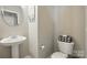 This bathroom has a pedestal sink and decorative storage at 820 Settlement St, Clover, SC 29710