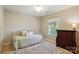 Cozy bedroom featuring a daybed with throw pillows, a wooden dresser, and natural light from the window at 820 Settlement St, Clover, SC 29710