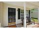 Inviting front porch with a dark front door, rocking chairs, and charming decor at 820 Settlement St, Clover, SC 29710