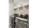 This laundry room features modern, front-loading machines and ample storage at 820 Settlement St, Clover, SC 29710