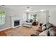 Bright living room featuring a fireplace, hardwood floors, large windows, and neutral tones at 820 Settlement St, Clover, SC 29710