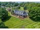 Beautiful home with a well-manicured lawn and mature trees creating an inviting and picturesque setting at 8698 Rocky River Rd, Harrisburg, NC 28075