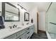 Modern bathroom with dual sinks, stylish fixtures, and a glass-enclosed shower for a spa-like experience at 8698 Rocky River Rd, Harrisburg, NC 28075