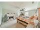 Bright bedroom with a large ceiling fan, fire place, and natural light from two windows at 8698 Rocky River Rd, Harrisburg, NC 28075