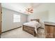 Comfortable bedroom featuring a wooden bed frame, ceiling fan and natural light, perfect for relaxation at 8698 Rocky River Rd, Harrisburg, NC 28075