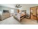 Cozy bedroom featuring a neutral color palette, ceiling fan and ample natural light for relaxation at 8698 Rocky River Rd, Harrisburg, NC 28075