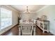 Formal dining room with hardwood floors and natural lighting at 8698 Rocky River Rd, Harrisburg, NC 28075
