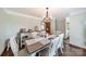 An elegant dining room featuring stylish chandelier, a large table perfect for gatherings, and hardwood floors at 8698 Rocky River Rd, Harrisburg, NC 28075