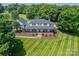 Aerial view of a beautiful home with a large yard and meticulously maintained landscaping at 8698 Rocky River Rd, Harrisburg, NC 28075