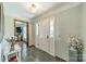 Welcoming foyer with stone tile flooring, white door and beautiful decor with an open view at 8698 Rocky River Rd, Harrisburg, NC 28075