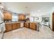 Open kitchen design with tile floors, wood cabinets, and modern appliances at 8698 Rocky River Rd, Harrisburg, NC 28075