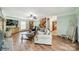 Inviting living room featuring wood floors, a ceiling fan, and a staircase to the upper level at 8698 Rocky River Rd, Harrisburg, NC 28075