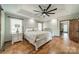 Large main bedroom featuring hardwood floors and tray ceiling at 8698 Rocky River Rd, Harrisburg, NC 28075