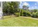 Lush backyard with healthy green grass, mature trees and garden, providing a serene and private outdoor oasis at 919 Cityscape Dr, Charlotte, NC 28205