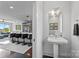 Modern bathroom with a pedestal sink and adjacent kitchen with bar seating at 919 Cityscape Dr, Charlotte, NC 28205