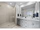 Modern bathroom with a glass walk-in shower, dual vanity, and gray cabinetry at 919 Cityscape Dr, Charlotte, NC 28205