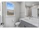 Contemporary bathroom featuring gray cabinetry, a vanity sink, and a window at 919 Cityscape Dr, Charlotte, NC 28205