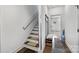 Light-filled entryway showcasing a staircase and practical storage with a bench and shoe rack at 919 Cityscape Dr, Charlotte, NC 28205