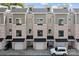 Charming townhome exterior with brick facade, private garages, black window trim, and rooftop terraces at 919 Cityscape Dr, Charlotte, NC 28205