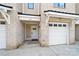 Charming townhouse exterior featuring a brick facade, garage, and inviting front entrance with a modern door at 919 Cityscape Dr, Charlotte, NC 28205