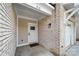 Inviting front entrance with brick accents, a modern door, and a well-maintained walkway leading to the home at 919 Cityscape Dr, Charlotte, NC 28205