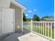 Balcony view of a green yard and other houses with a blue sky above at 9404 S Vicksburg Park Ct, Charlotte, NC 28210