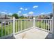Balcony view of a green yard and other houses with a blue sky above at 9404 S Vicksburg Park Ct, Charlotte, NC 28210