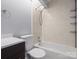 Tiled bathroom with modern dark vanity and bathtub at 9404 S Vicksburg Park Ct, Charlotte, NC 28210