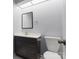Modern bathroom with dark vanity, sleek mirror, updated fixtures, and lighting at 9404 S Vicksburg Park Ct, Charlotte, NC 28210